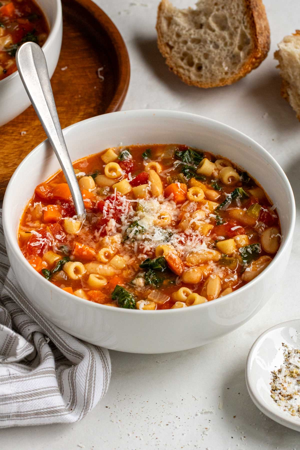 Close up of a bowl of white bean kale minestrone soup.