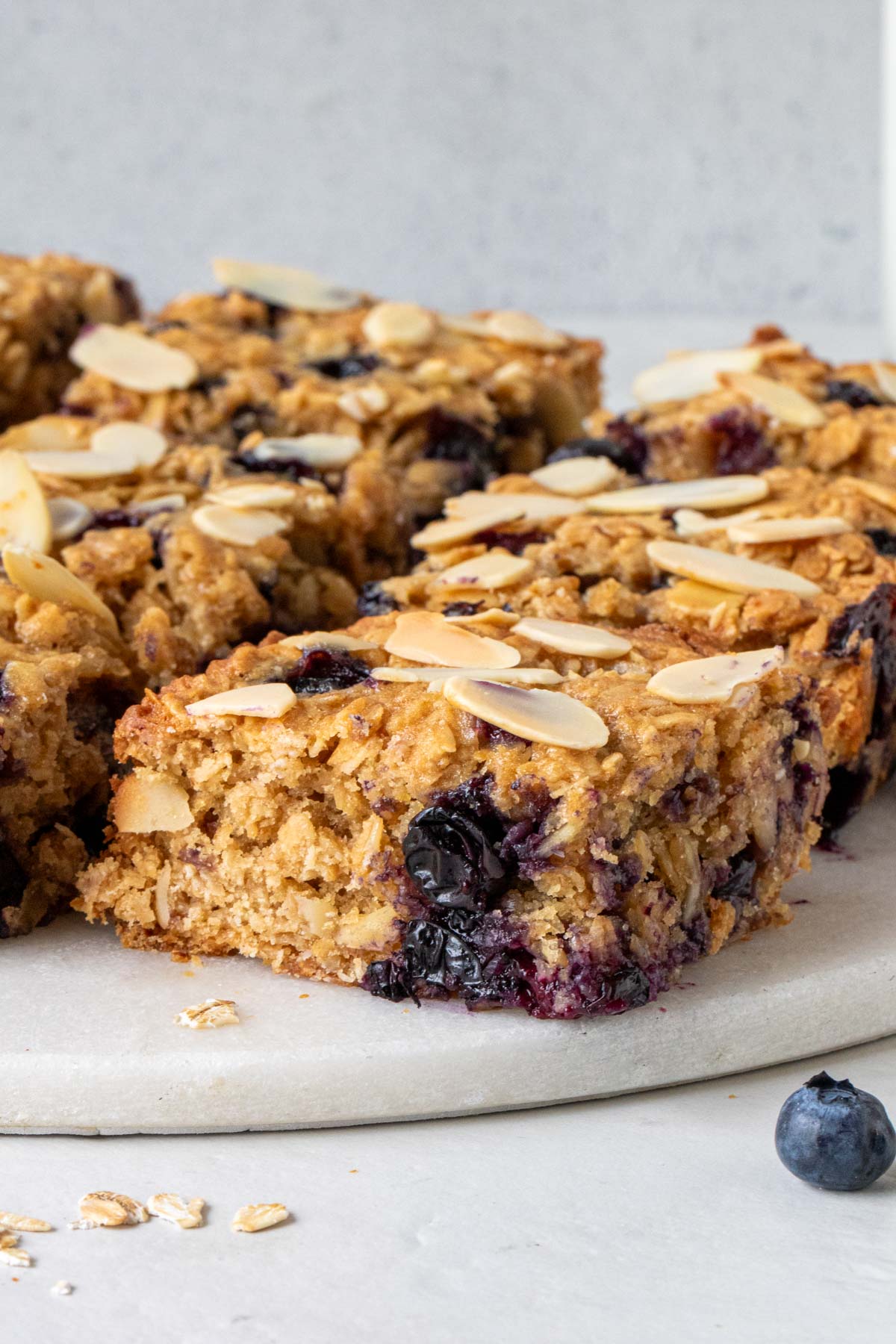 Close up of blueberry baked oatmeal bars on a white background.