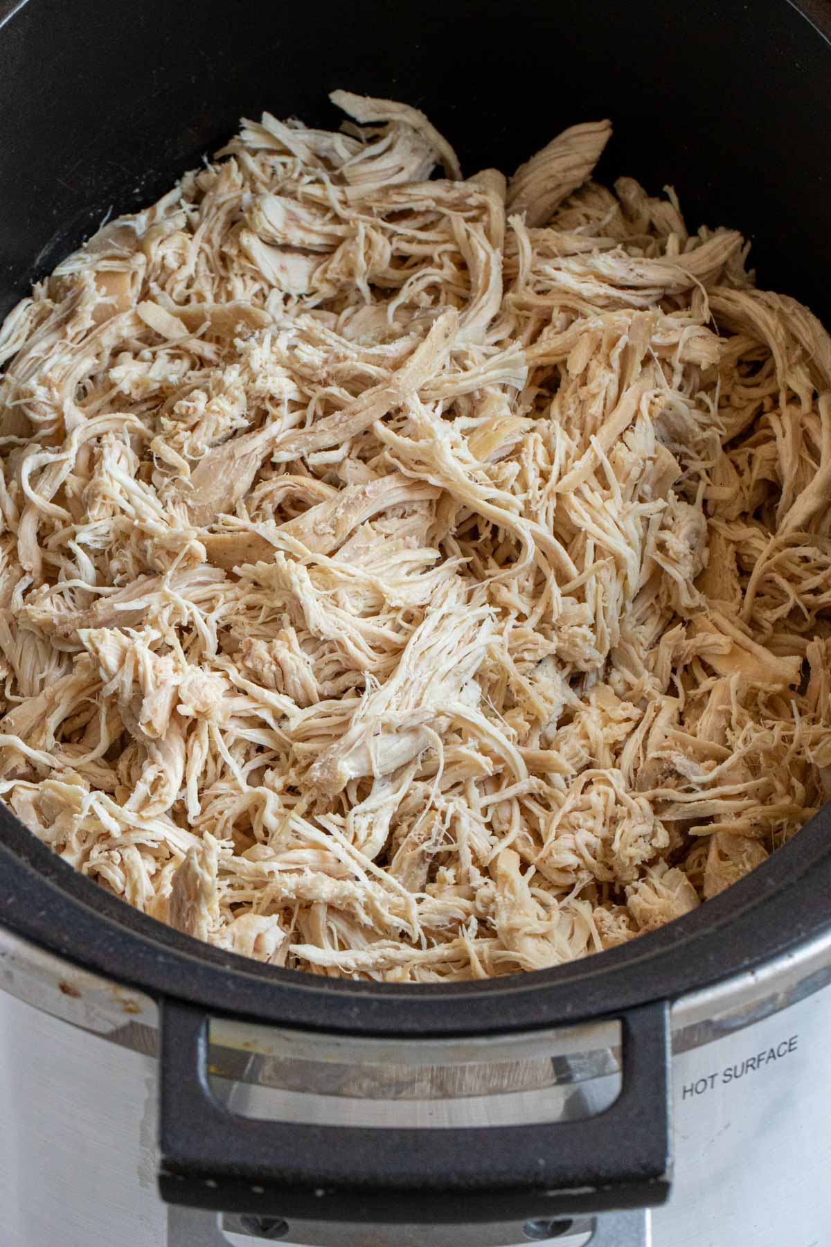 Close up of slow cooker shredded chicken.