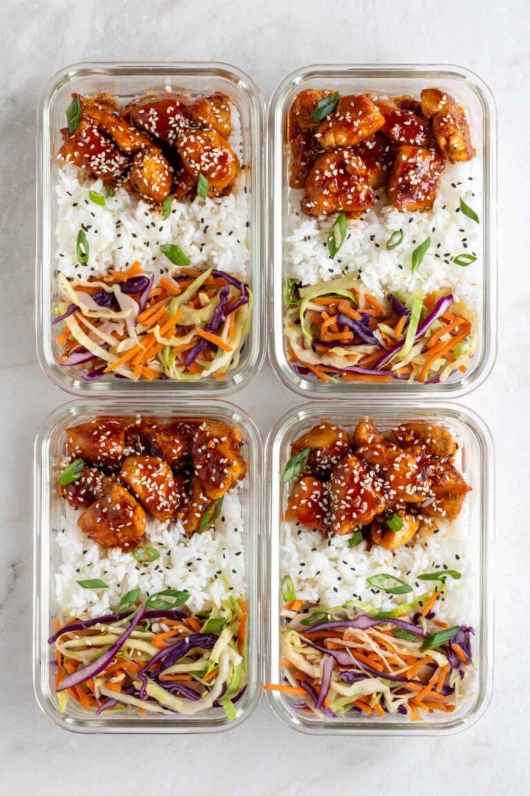 Four sticky chicken meal prep bowls in glass containers on a white background.