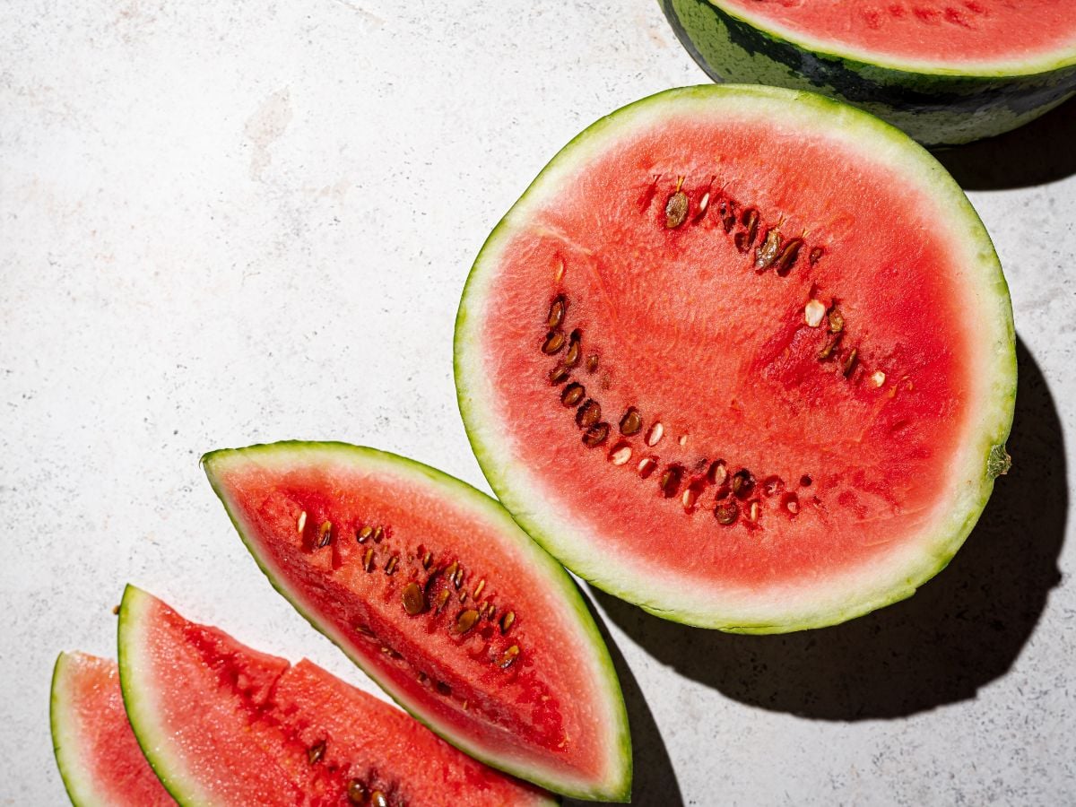 Sliced watermelon on a white background in the sun.