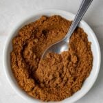 Homemade garam masala spice blend in a small white bowl.