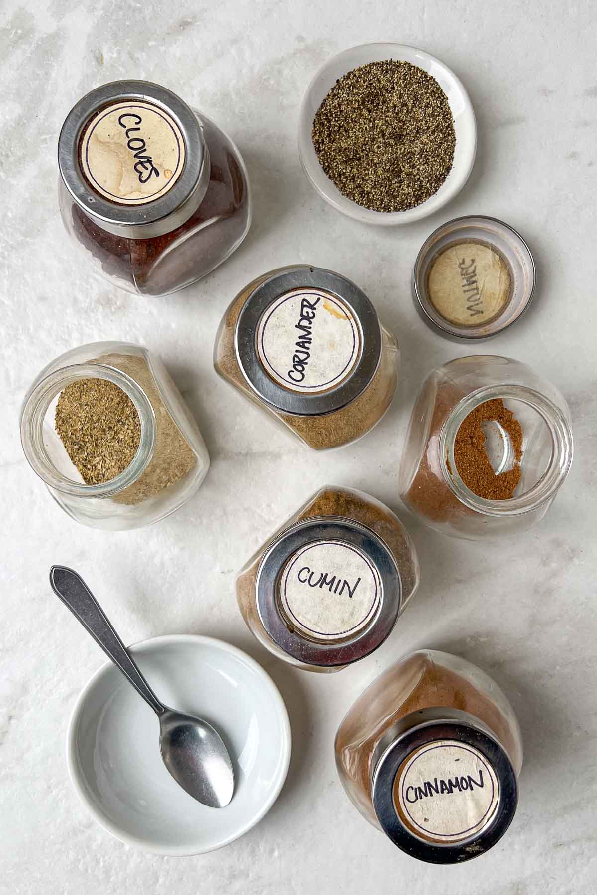 Ingredients for garam masala: ground cumin, ground coriander, ground cardamom, ground cinnamon, ground cloves, ground nutmeg, and black pepper.