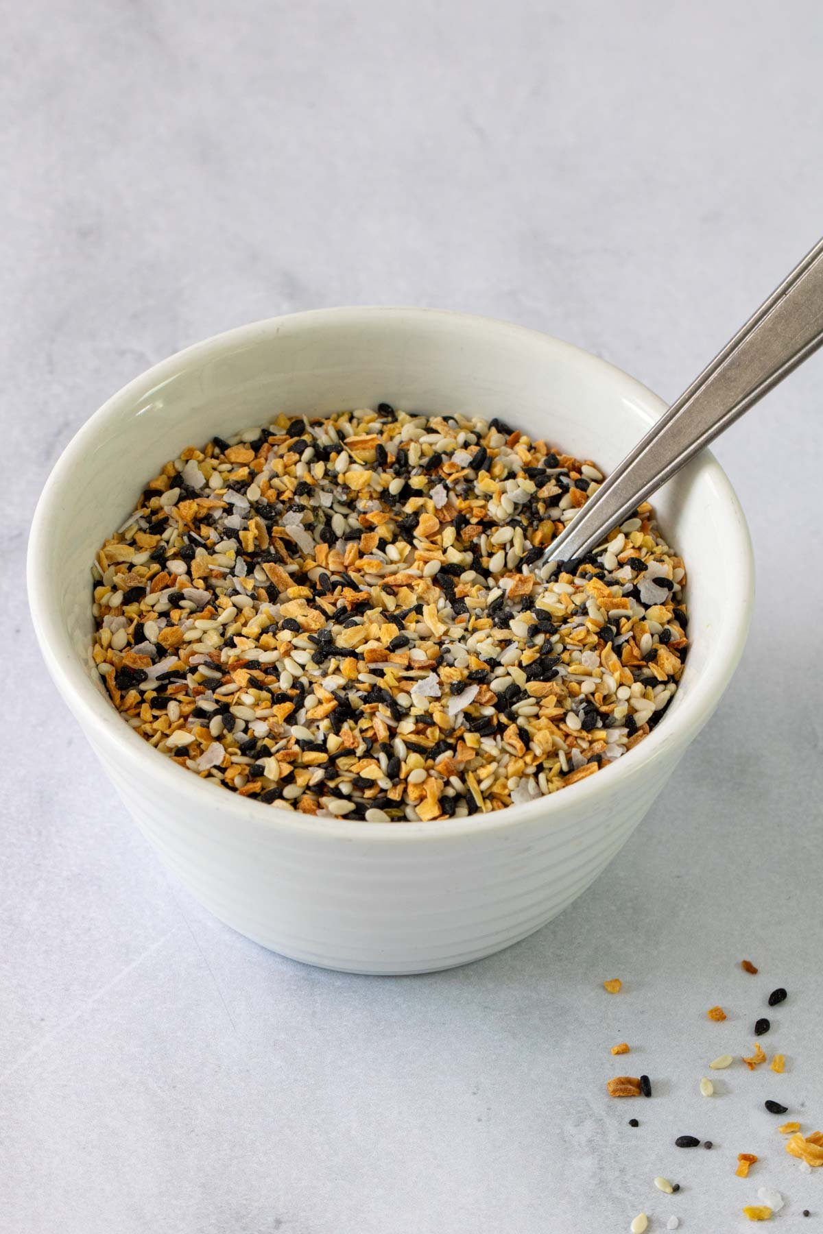 Close up of small bowl with everything bagel seasoning. 