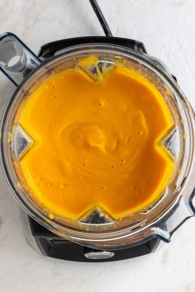 Blender with puréed carrot ginger soup with coconut milk.