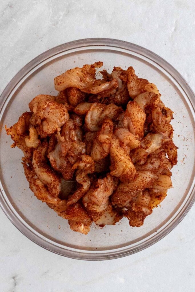 Bowl with chicken strips coated in fajita seasoning.