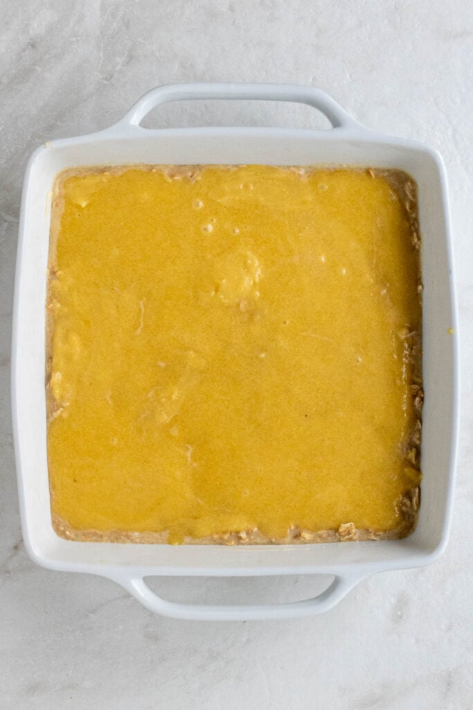 White baking with baked oat batter and frangipane batter on top. 