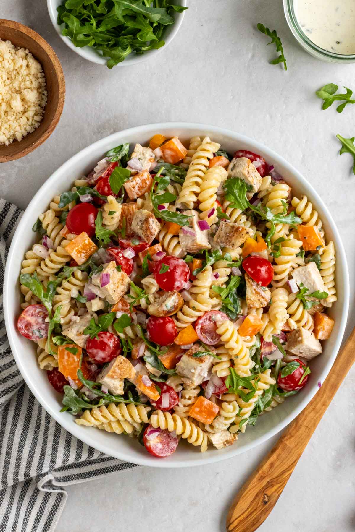 Bowl of chicken and pasta salad on a white background.