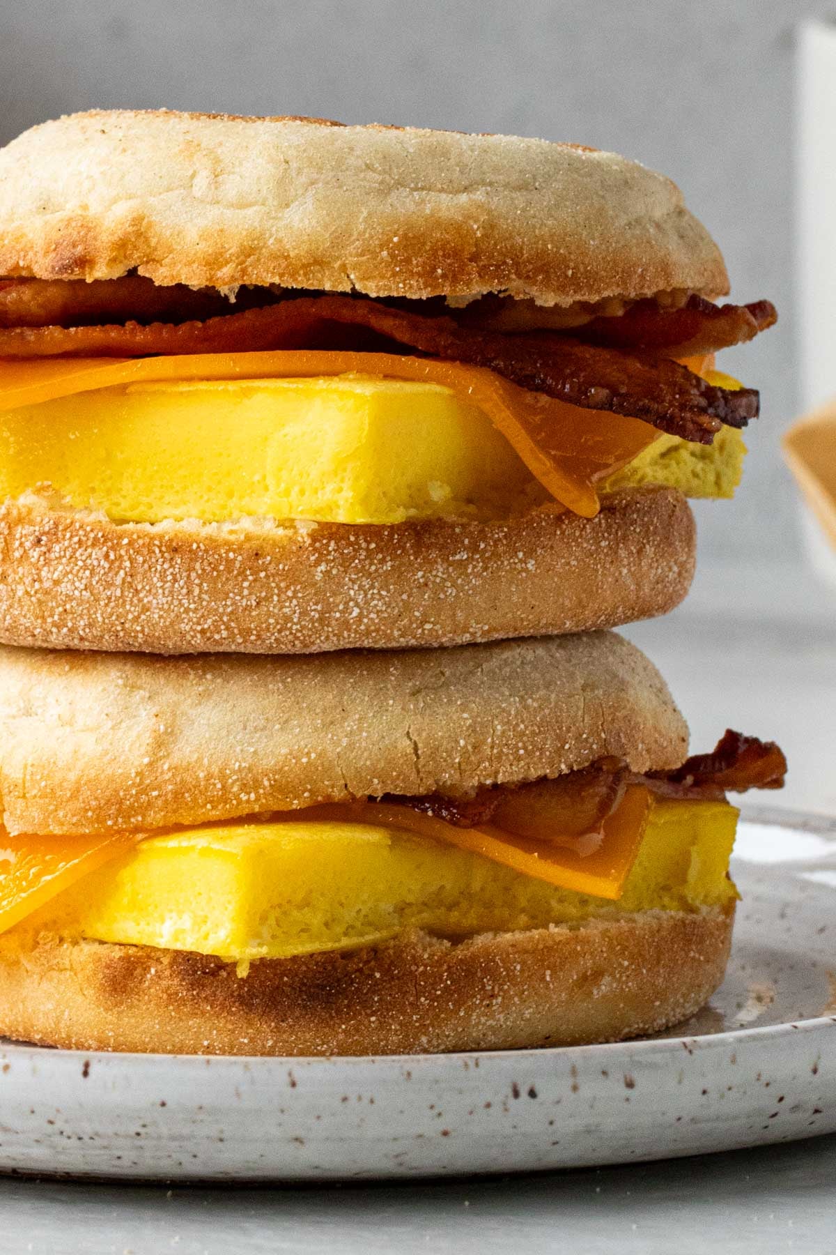 Close up make-ahead breakfast sandwiches on a plate on a white background.