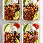 Four meal prep tofu burrito bowls in glass containers on a white background.