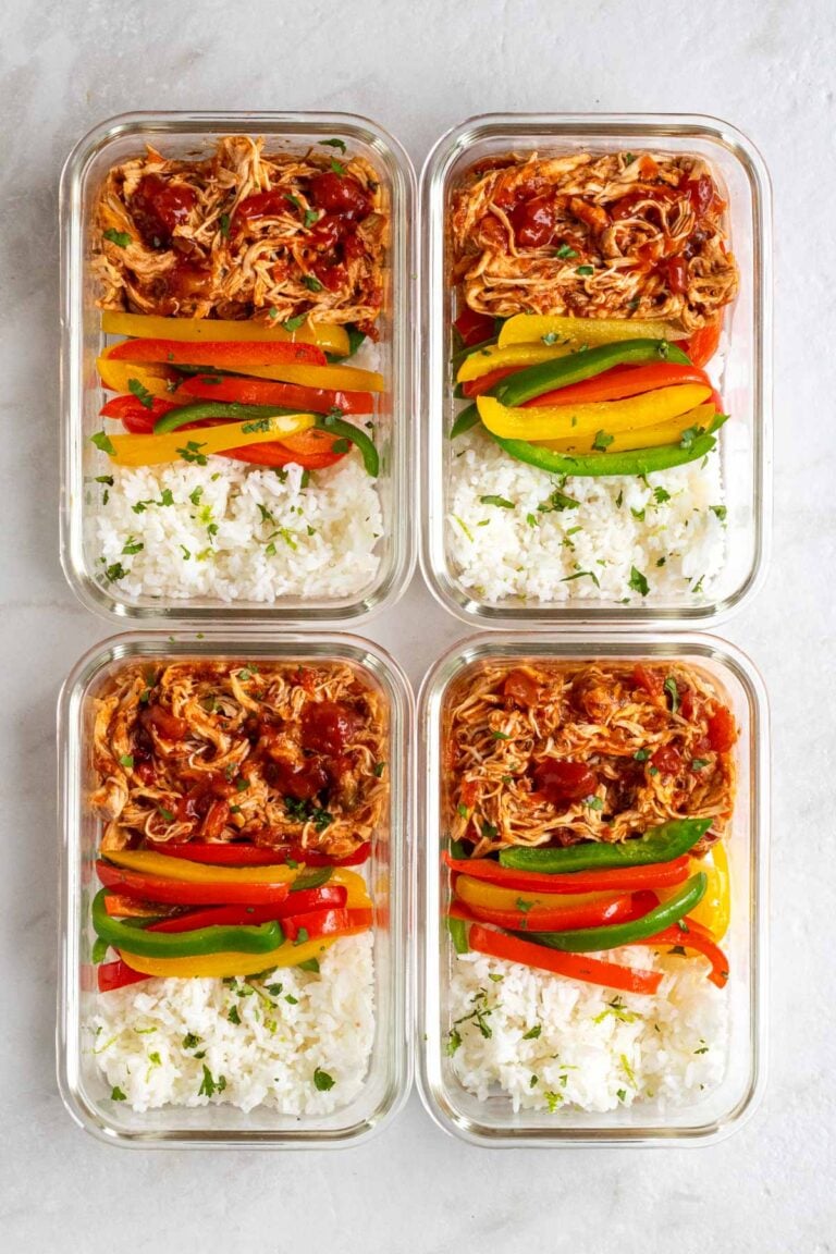 Four glass containers of salsa chicken meal prep bowls.