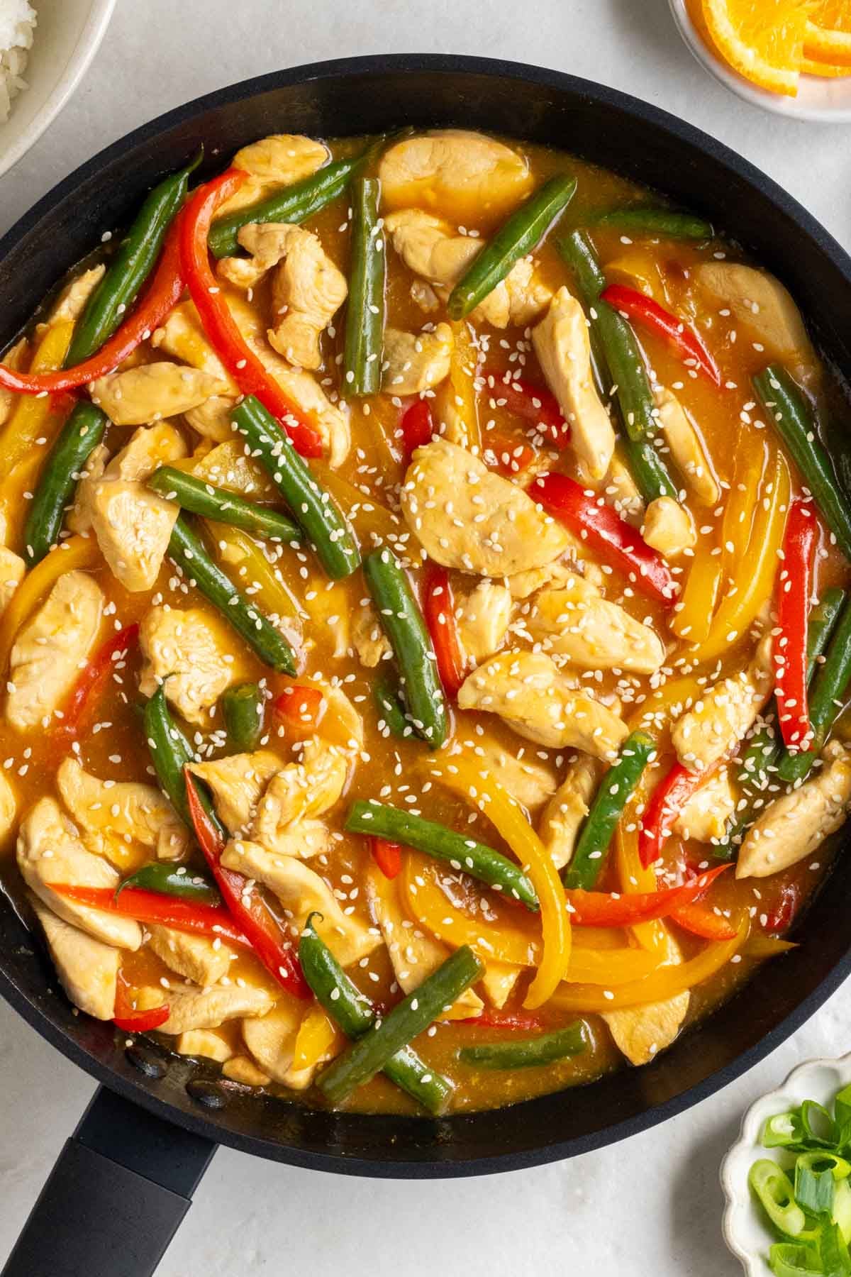 Pan with orange chicken stir fry.