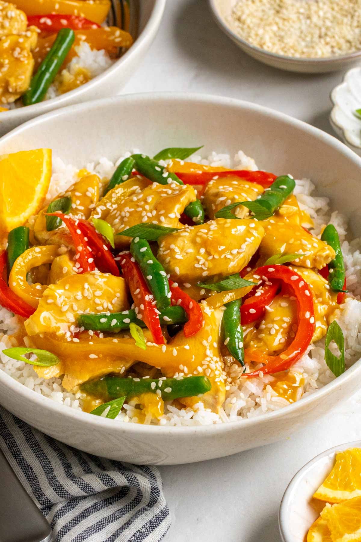 Orange chicken stir fry in a bowl.