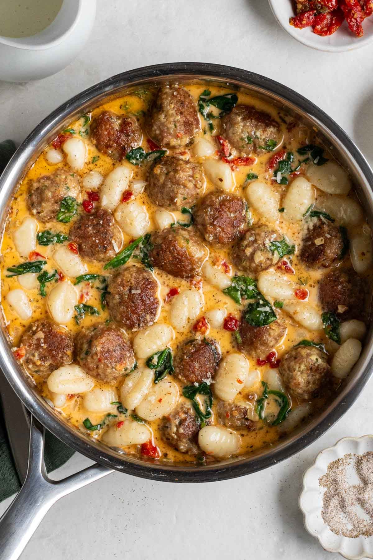 Pan of chicken meatballs and gnocchi in a Tuscan sauce.